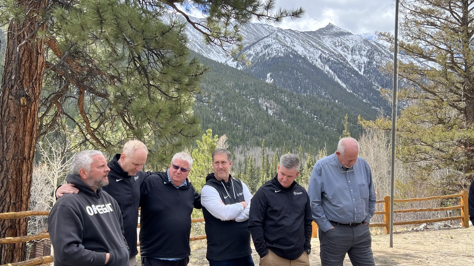 A group of Retreat attendees pausing together with the Colorado mountains behind them.